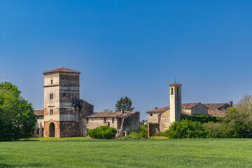 Abandoned rural building dominating green wheat field in Pojana Maggiore, Veneto, Italy