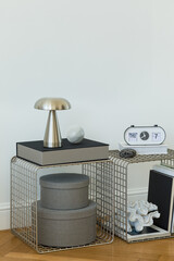 Elegant bedroom corner with chrome lamp, abstract art, and monochrome decor accents.