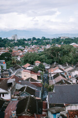 Dense Residential Area with Red Tiled Roofs and Mountain Backdrop
