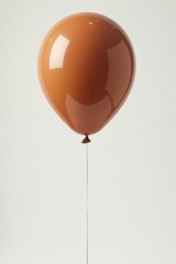 Obraz premium Single brown balloon, softly lit against white , brown, party, studio shot