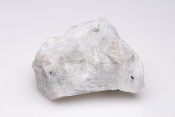 Close-up view of a rough, translucent mineral specimen with subtle green hues against a plain white...