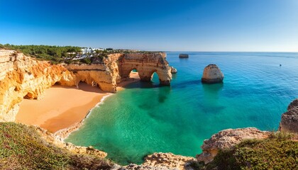 view of beautiful marinha beach with crystal clear turquoise water near carvoeiro town algarve region portugal