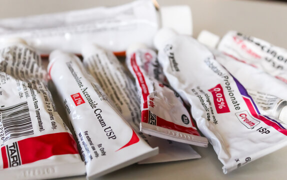 A grouping of prescription corticosteroid skin cream tubes to treat various dermatological conditions.