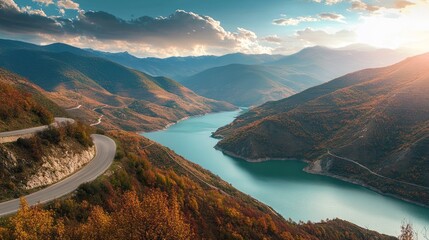 Scenic mountain road winding by a tranquil autumn lake