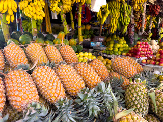 A bunch of pineapples are displayed in a pile