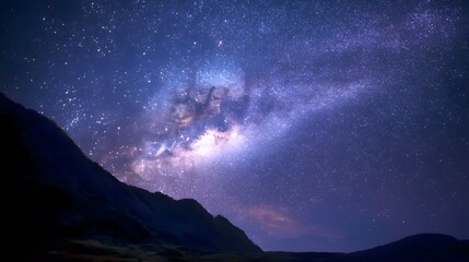 Naklejka premium Stunning Clear Night Sky Full of Stars with the Milky Way Over Majestic Mountains in a Serene Landscape