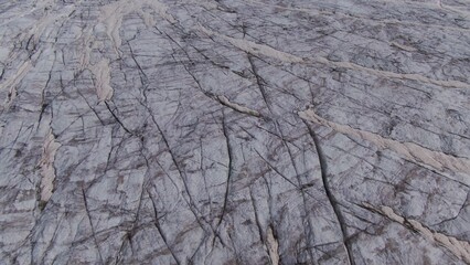 Top view of a gentle rocky snow-covered mountain slope. Mount Elbrus aerial view from a quadcopter, close-up
