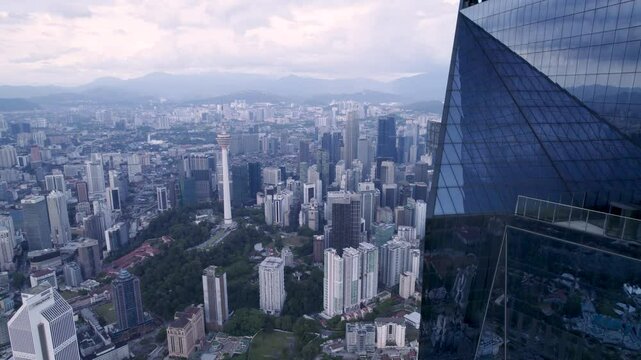 An upclose view of a Tip of the Merdeka 118 tower megastructure in Kuala Lumpur, Malaysia, office tower with blue windows