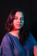 Young woman portrait with blue and purple light