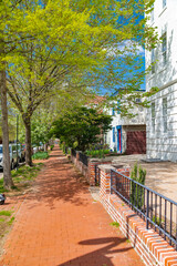 red brick sidewalk along a row of traditional townhouses in Washington, D.C.