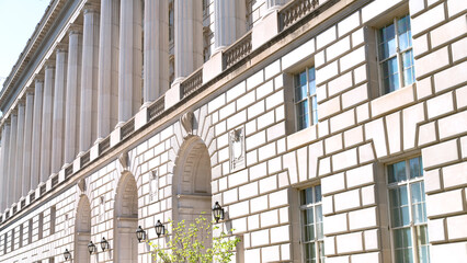 Symmetrical white monumental columns on the facade of the building.