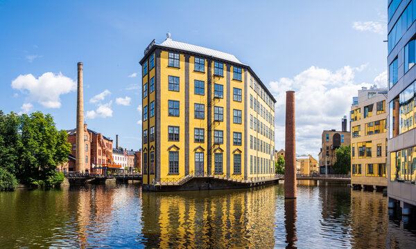 Norrk&ouml;ping, Sweden - July 30, 2024: Panoramic view of the Strykj&auml;rn building, a former weaving mill in the old industrial area on the Motala river, home to the Museum of Work (Arbetets museum).