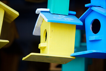 Colorful Wooden Birdhouses Hanging on a Display with Bright Colors