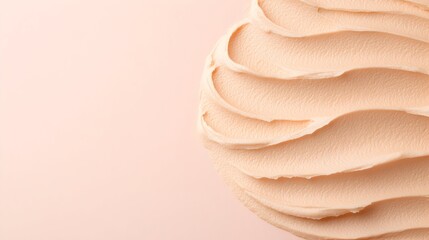 Swirled, pale peach cream texture on a pink background