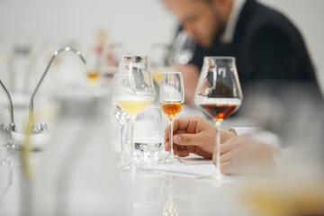 Blind tasting, close up. Sommelier makes notes on the tasting card. 