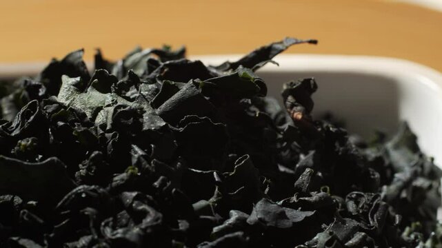 Dried wakame seaweed on a kitchen table. Dry laminaria, asian dish close up.