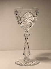 Elegant crystal glass with intricate design on a plain background