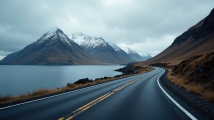 Serene Journey Along a Coastal Highway Winding Through Majestic Snow-Capped Mountains and a Tranquil Lake
