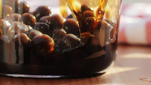 Cooking, boiling brown sugar flavor tapioca pearl balls, chinese food, ingredient of bubble tea, preparing food and drink, close up, recipe cookbook steps design concept.