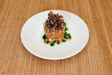 A plate of food with a green sauce on top