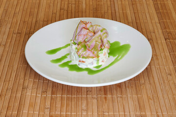 A plate of food with a green sauce on top