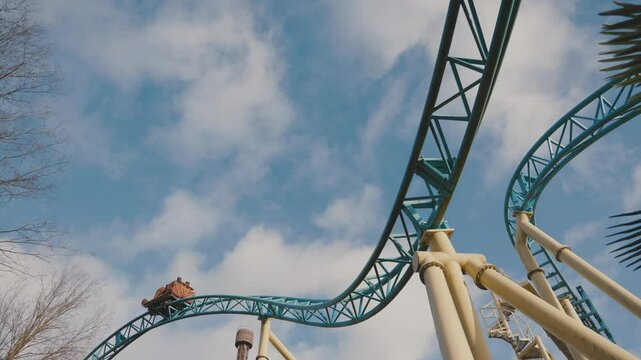 Upward View of Roller Coaster Train on Steel Loop Track