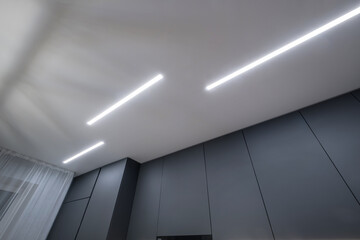 suspended ceiling with halogen spots lamps in form of squares and rectangles and drywall...