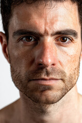 Obraz premium Pensive Gaze: Close-Up Portrait of a Man in his Early 40s with a Short, Dark Brown Beard, Wearing a Blue Button-Down Shirt, Contemplative Expression, Intense Eyes, High-Definition Photography