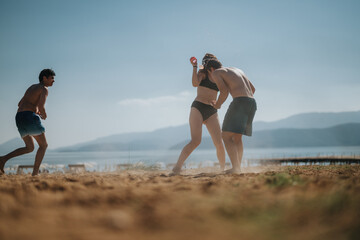 Friends having fun playing beach games under the bright sun by the sea, showcasing friendship and leisure. Moments of joy and active lifestyle in a summer setting filled with fun and excitement.