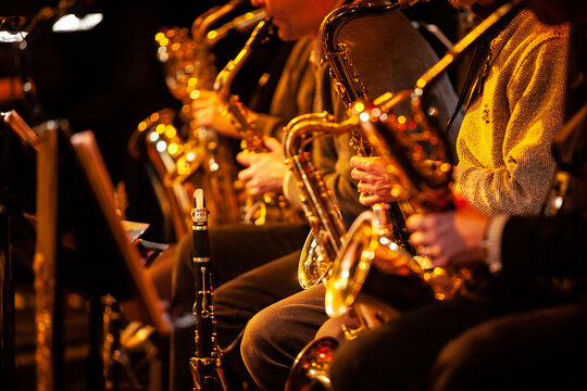 Big Band Saxophones. A view across the sax section in a big band performing together live on stage.