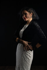 Elegant Woman in Vintage Polka Dot Dress with Veil and Gloves