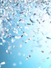 Fototapeta premium Festive silver confetti shower on light blue background creates a magical and celebratory atmosphere perfect for party events and holiday season with a bright and cheerful mood