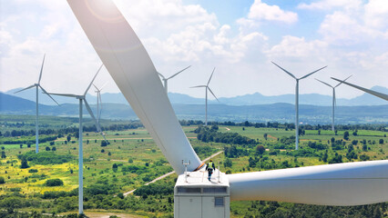 Expert team maintaining and inspecting wind turbines efficient clean energy production. surrounded...