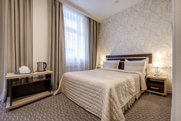 Fototapeta premium Interior of modern luxure bedroom in studio apartments with double bed with pillows