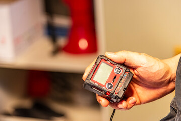 Gas detector for enclosed spaces, held by a crew member aboard a merchant vessel - essential safety...