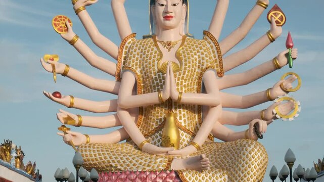 Colorful statue of Guanyin, the Goddess of Mercy and Compassion in East Asian Buddhism with eighteen arms in Wat Plai Laem temple on Koh Samui island in Thailand. Travel and touristic landmark