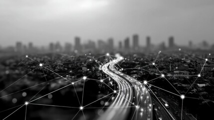 Black and white aerial shot of a city highway at night, showing interconnectedness.