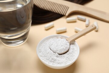 Collagen capsules, hair lock, powder, water and comb on beige background, closeup