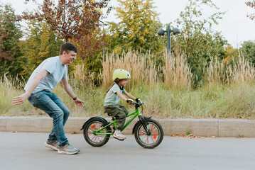Quality Time Together – Father Teaching Daughter to Ride a Bike Outdoors