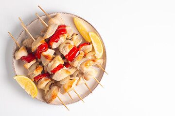Grilled chicken skewers. Satay with side lemon and salad. Kebab with sauces. 