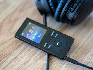 MP3 music player with headphones. List of favorite music artists and songs. Todays top hits