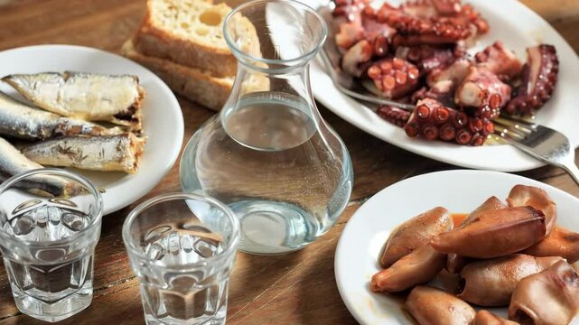 Turkish raki, greek ouzo or tsipouro, aperitif drink and starters closeup view 