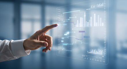 Hand Interacting with Digital Chart Display on Transparent Interface in Brightly Lit Office with Blurred Background