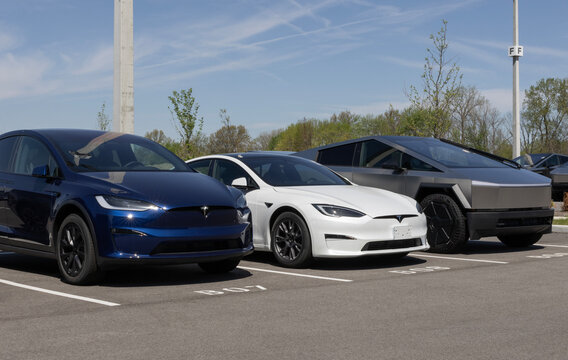 Tesla Model X, Model S, and Cybertruck display at a dealership. Tesla offers owners a network of over 60,000 Superchargers.