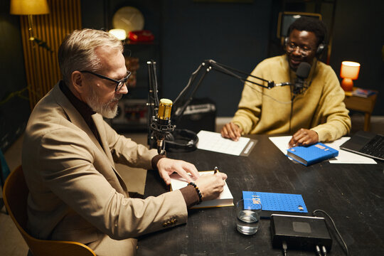 Author signing his book during interview in studio