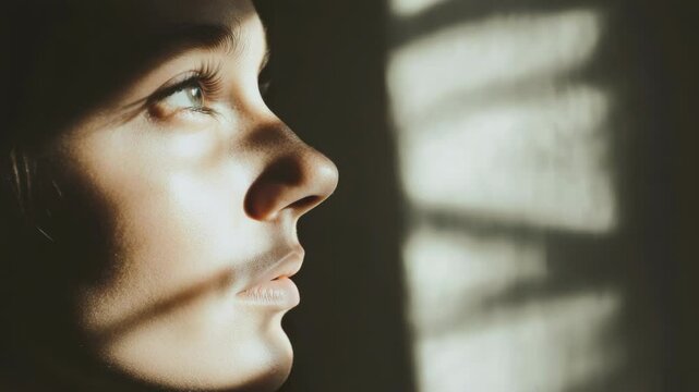 A person holds their hand to their face, conveying sadness or discomfort