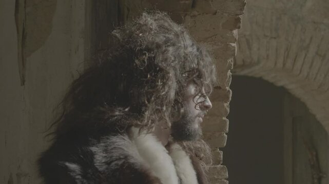 medieval figure gazes into the wind