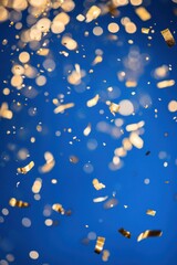 Fototapeta premium Festive golden confetti falling against a vibrant blue background creating a celebratory mood perfect for events and special occasions capturing the essence of joy and achievement