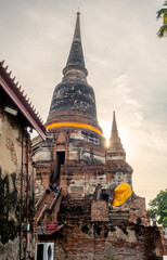 Wat Yai Chaimongkol, one of the UNESCO World Heritage place Ayudhaya, Thailand, ancient pagoda and buildings with surrounding a lot of buddha statues in outdoor under blue sky in summer