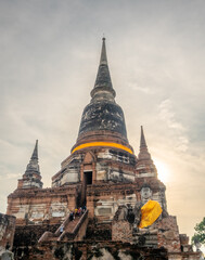 Wat Yai Chaimongkol, one of the UNESCO World Heritage place Ayudhaya, Thailand, ancient pagoda and buildings with surrounding a lot of buddha statues in outdoor under blue sky in summer